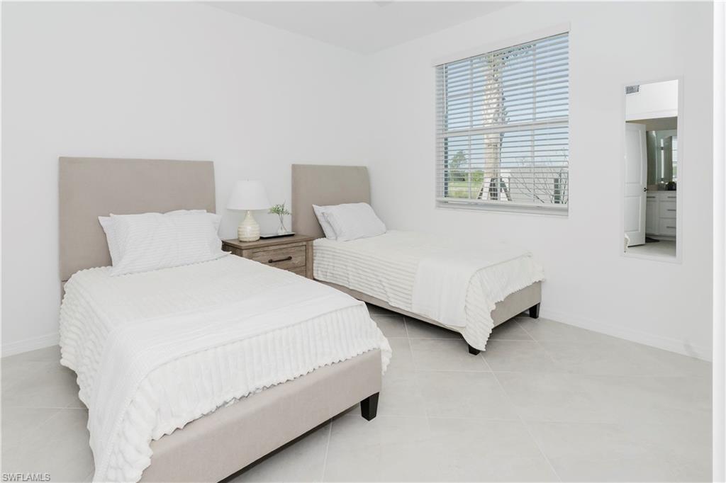 15285 Grn Acrs Avenue, Unit 418 Babcock Ranch, FL 33982 - Photo 27 of 49 a bedroom with two beds and a couch