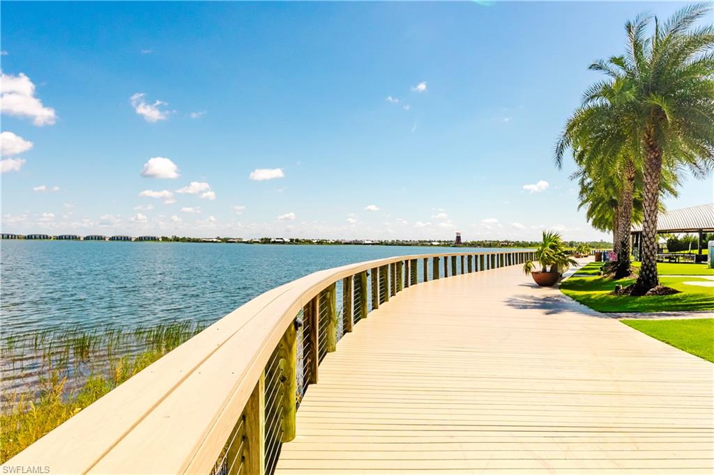 15285 Grn Acrs Avenue, Unit 418 Babcock Ranch, FL 33982 - Photo 48 of 49 a view of swimming pool with outdoor seating and lake