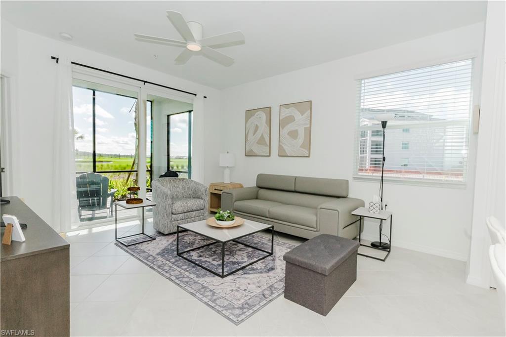15285 Grn Acrs Avenue, Unit 418 Babcock Ranch, FL 33982 - Photo 10 of 49 a living room with furniture and a large window
