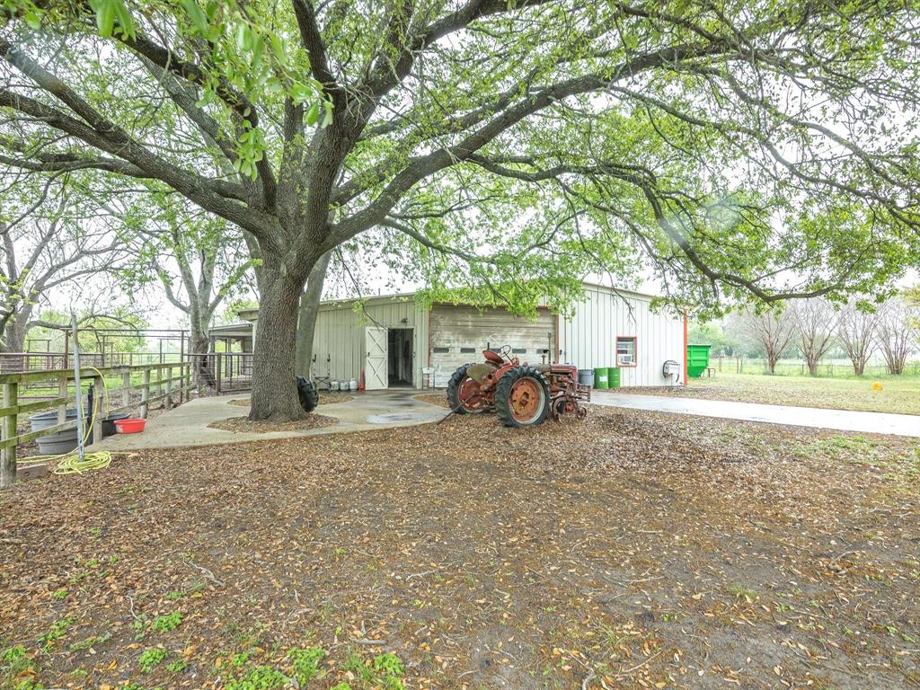 1302 Forreston Road Waxahachie, TX 75165 - Photo 12 of 39 a view of a house with backyard and a tree