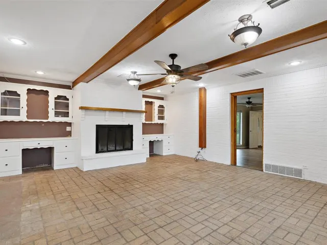 a view of an empty room with a fireplace