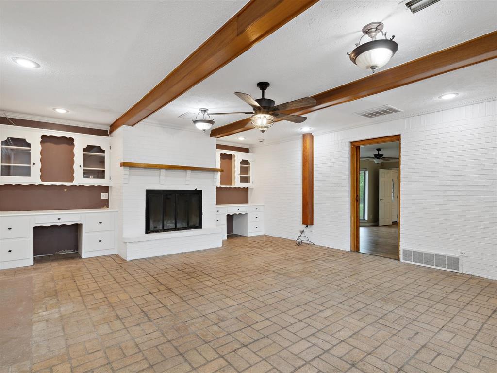 1302 Forreston Road Waxahachie, TX 75165 - Photo 20 of 39 a view of an empty room with a fireplace and a window