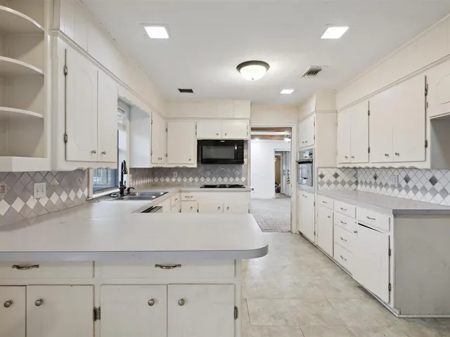 a kitchen with stainless steel appliances a refrigerator sink and cabinets