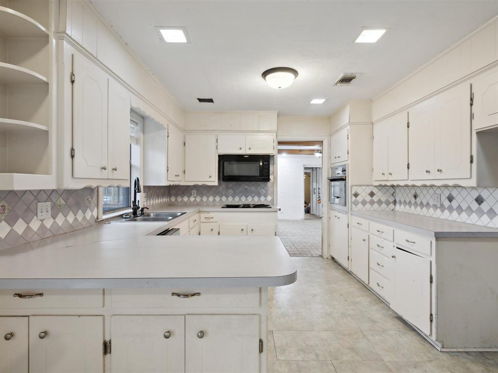 1302 Forreston Road Waxahachie, TX 75165 - Photo 23 of 39 a kitchen with a sink a stove and cabinets