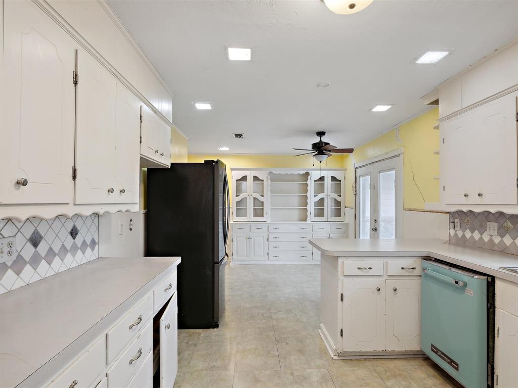 1302 Forreston Road Waxahachie, TX 75165 - Photo 26 of 39 a kitchen with a refrigerator and a sink