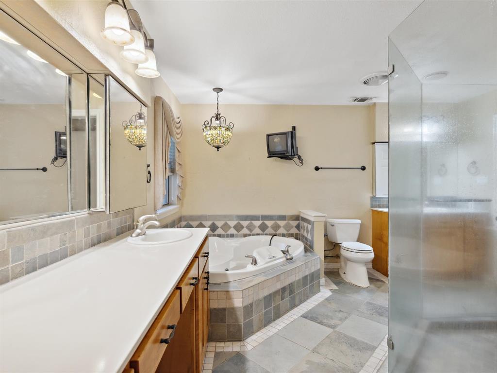 1302 Forreston Road Waxahachie, TX 75165 - Photo 27 of 39 a bathroom with a bathtub and a sink