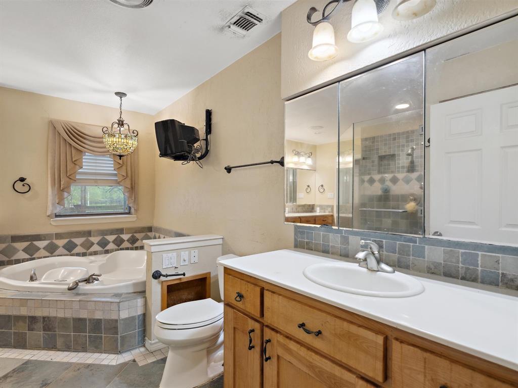 1302 Forreston Road Waxahachie, TX 75165 - Photo 30 of 39 a bathroom with a sink toilet and shower