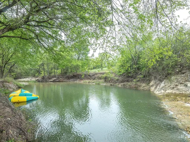 a lake view with a house in the background