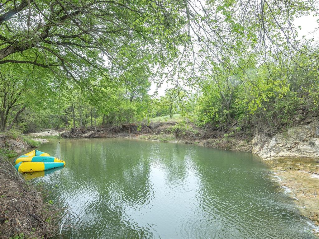 1302 Forreston Road Waxahachie, TX 75165 - Photo 3 of 39 a lake view with a house in the background