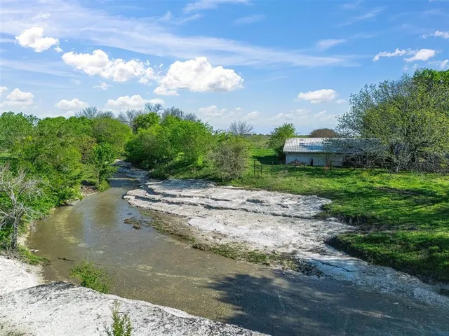 a view of a street with a yard
