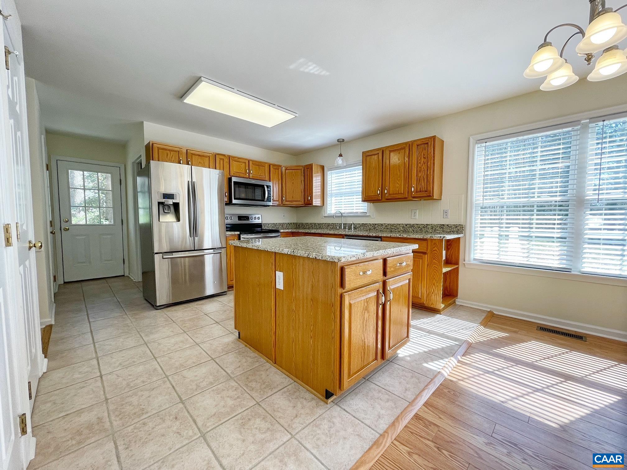 216 Rudolph Street Ruckersville, VA 22968 - Photo 11 of 39 a kitchen with stainless steel appliances granite countertop a stove top oven a refrigerator a sink and dishwasher