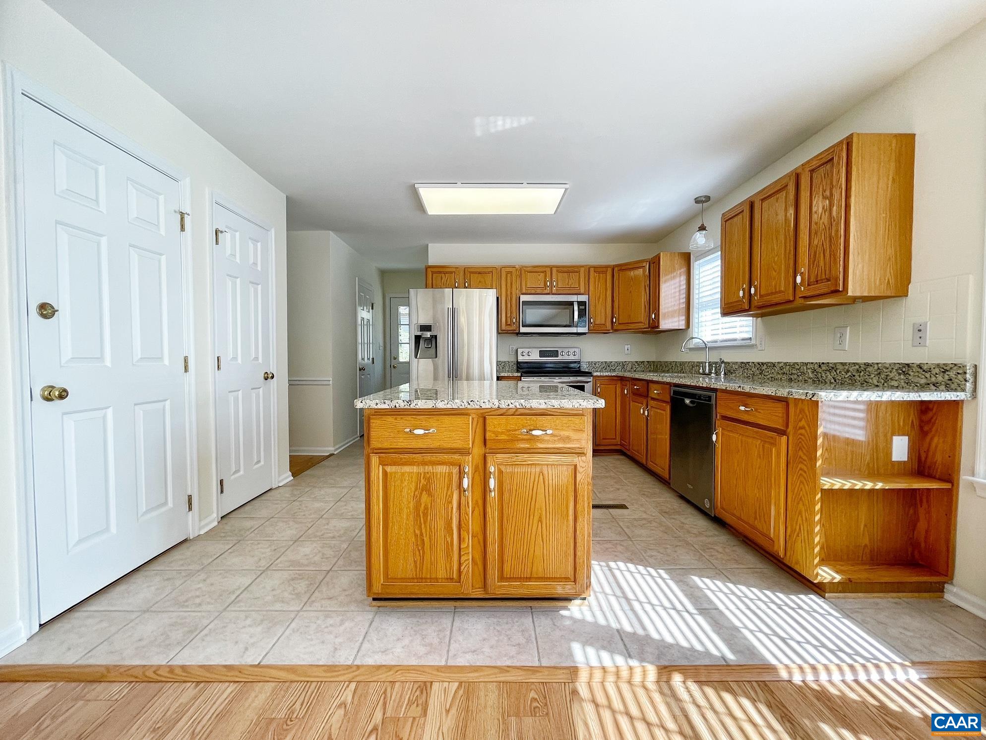 216 Rudolph Street Ruckersville, VA 22968 - Photo 12 of 39 a large kitchen with stainless steel appliances granite countertop a stove a sink dishwasher and a refrigerator