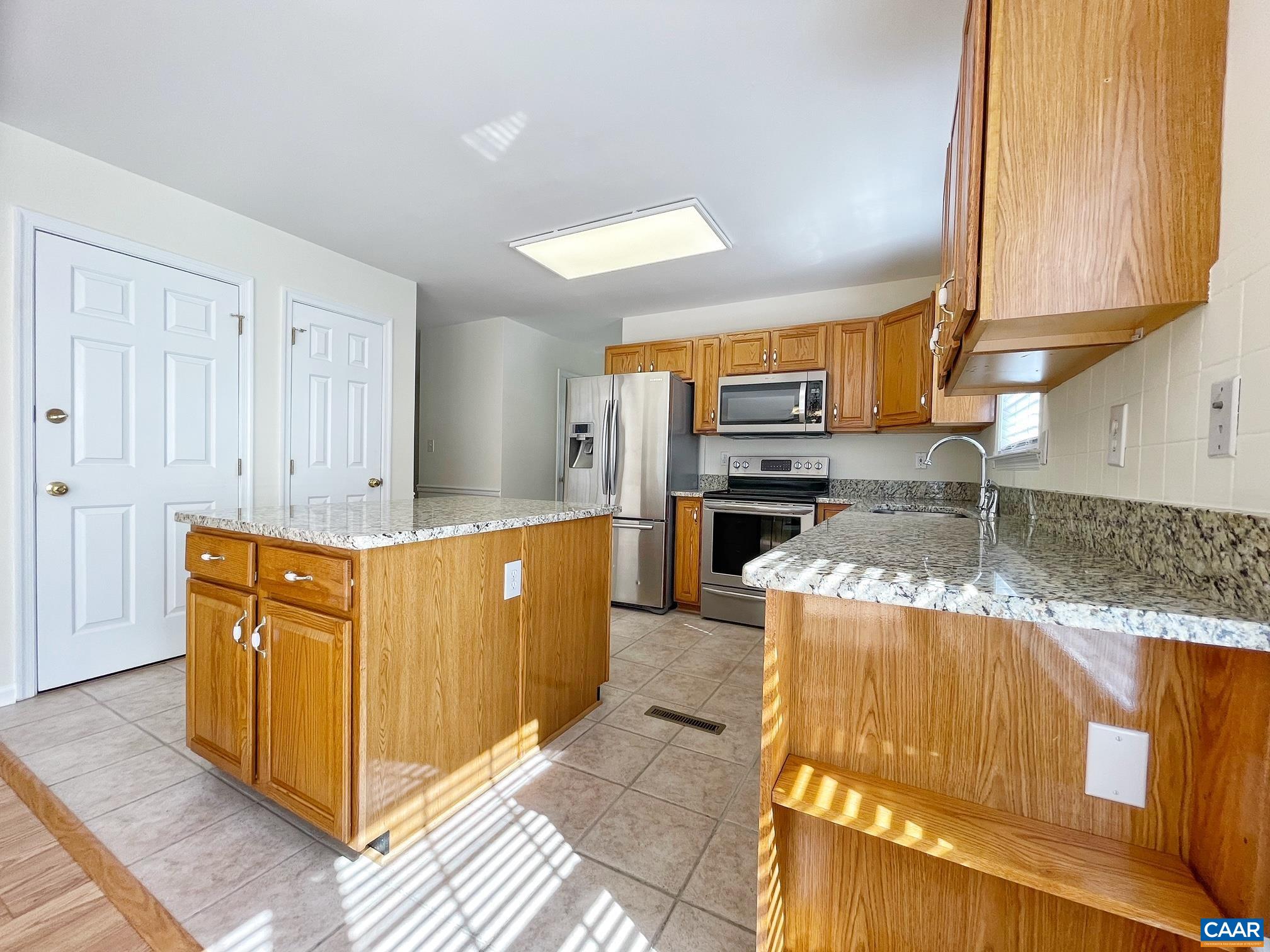 216 Rudolph Street Ruckersville, VA 22968 - Photo 14 of 39 a kitchen with stainless steel appliances granite countertop a stove a sink and a microwave