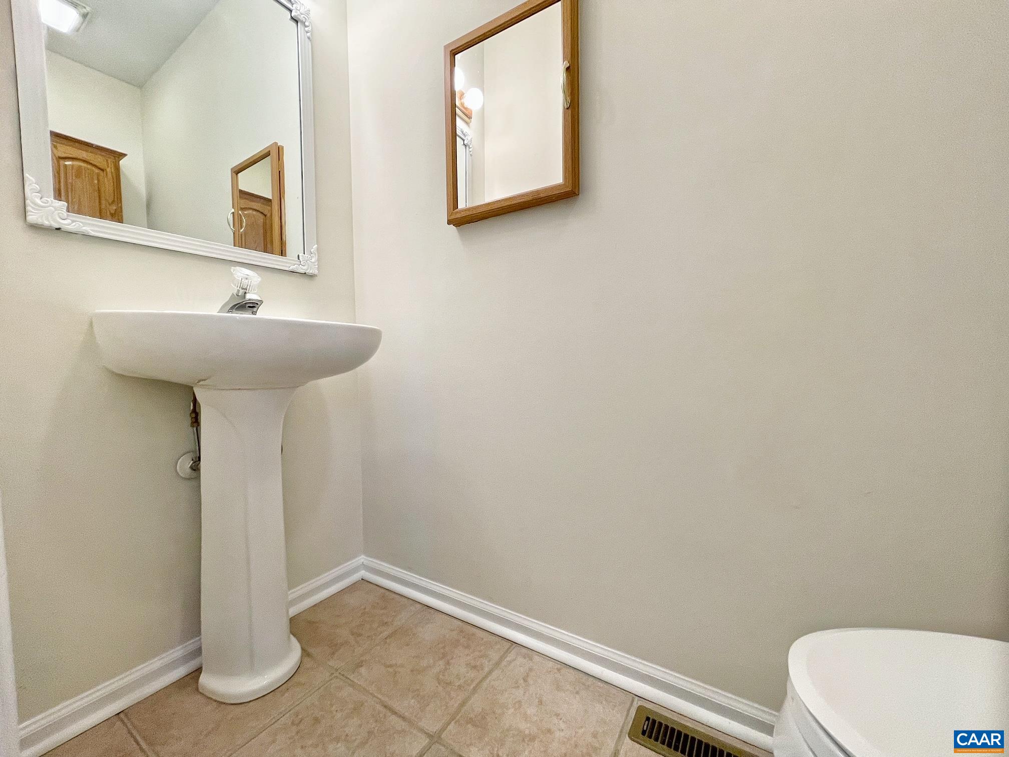 216 Rudolph Street Ruckersville, VA 22968 - Photo 16 of 39 a bathroom with a sink a mirror and a toilet