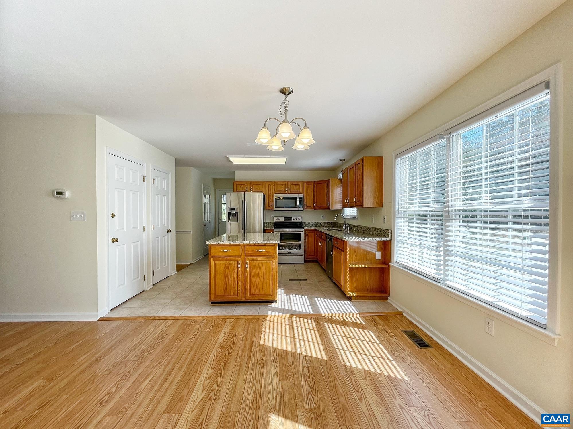 216 Rudolph Street Ruckersville, VA 22968 - Photo 17 of 39 a large kitchen with stainless steel appliances granite countertop a lot of cabinets and wooden floor