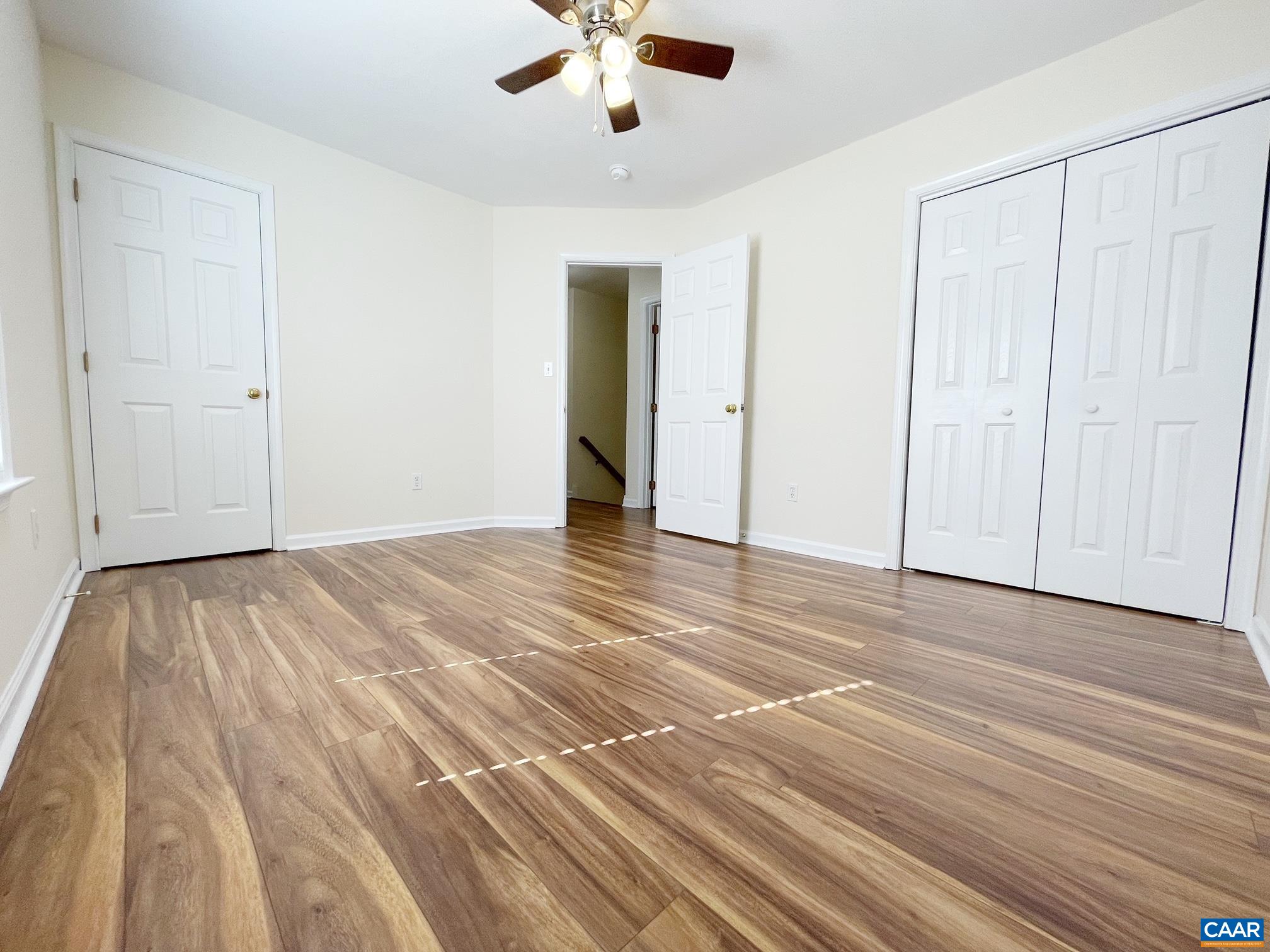 216 Rudolph Street Ruckersville, VA 22968 - Photo 23 of 39 a view of a livingroom with wooden floor and a ceiling fan