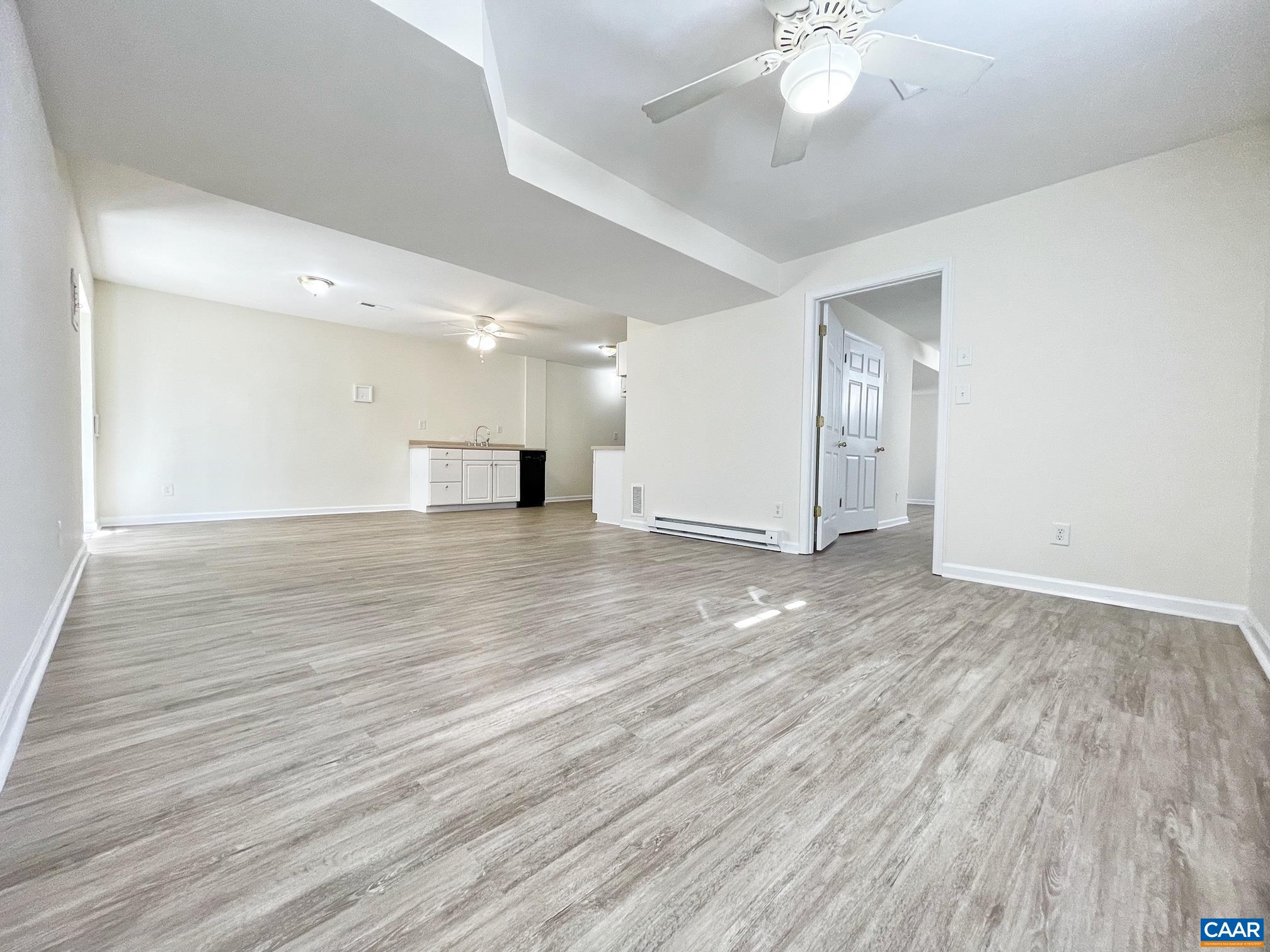 216 Rudolph Street Ruckersville, VA 22968 - Photo 26 of 39 a view of an empty room with wooden floor and a chandelier fan