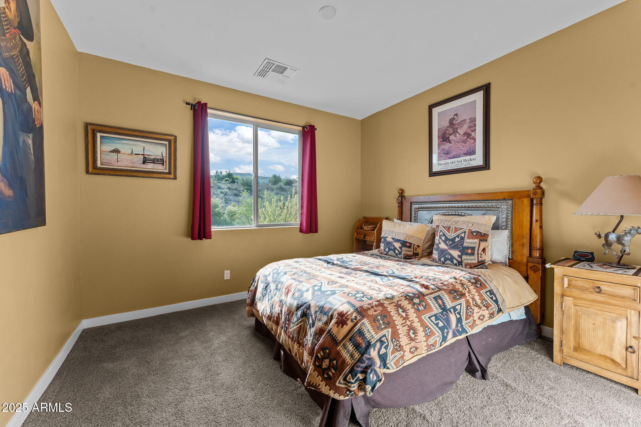 1900 West Ringo Road Wickenburg, AZ 85390 - Photo 22 of 37 a bedroom with a bed painting on the wall and a window