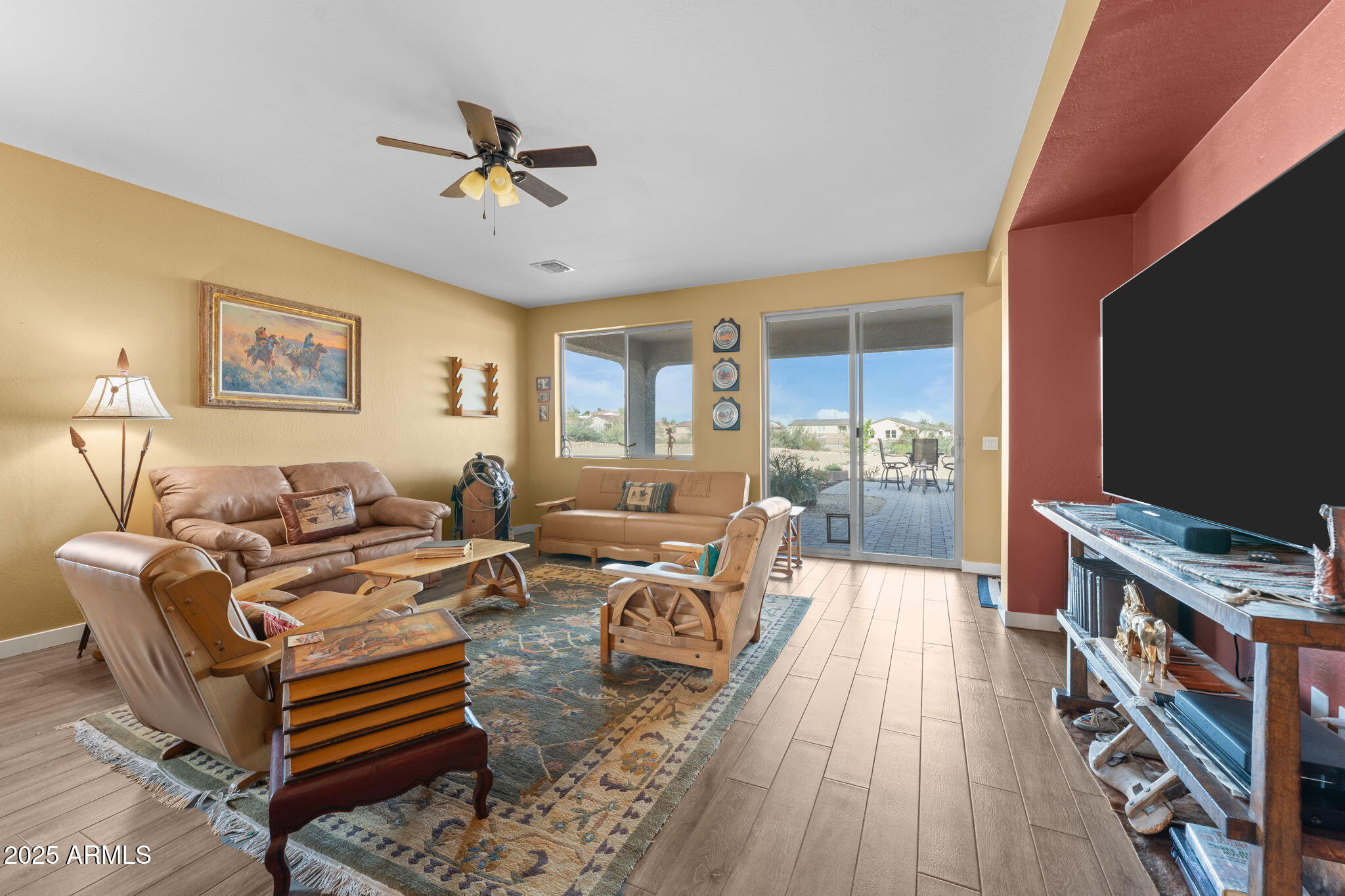 1900 West Ringo Road Wickenburg, AZ 85390 - Photo 4 of 37 a living room with furniture and a flat screen tv