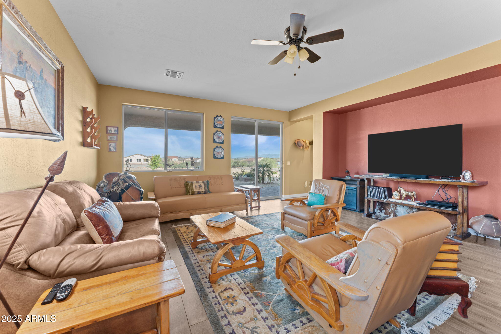 1900 West Ringo Road Wickenburg, AZ 85390 - Photo 5 of 37 a living room with furniture a flat screen tv and a table