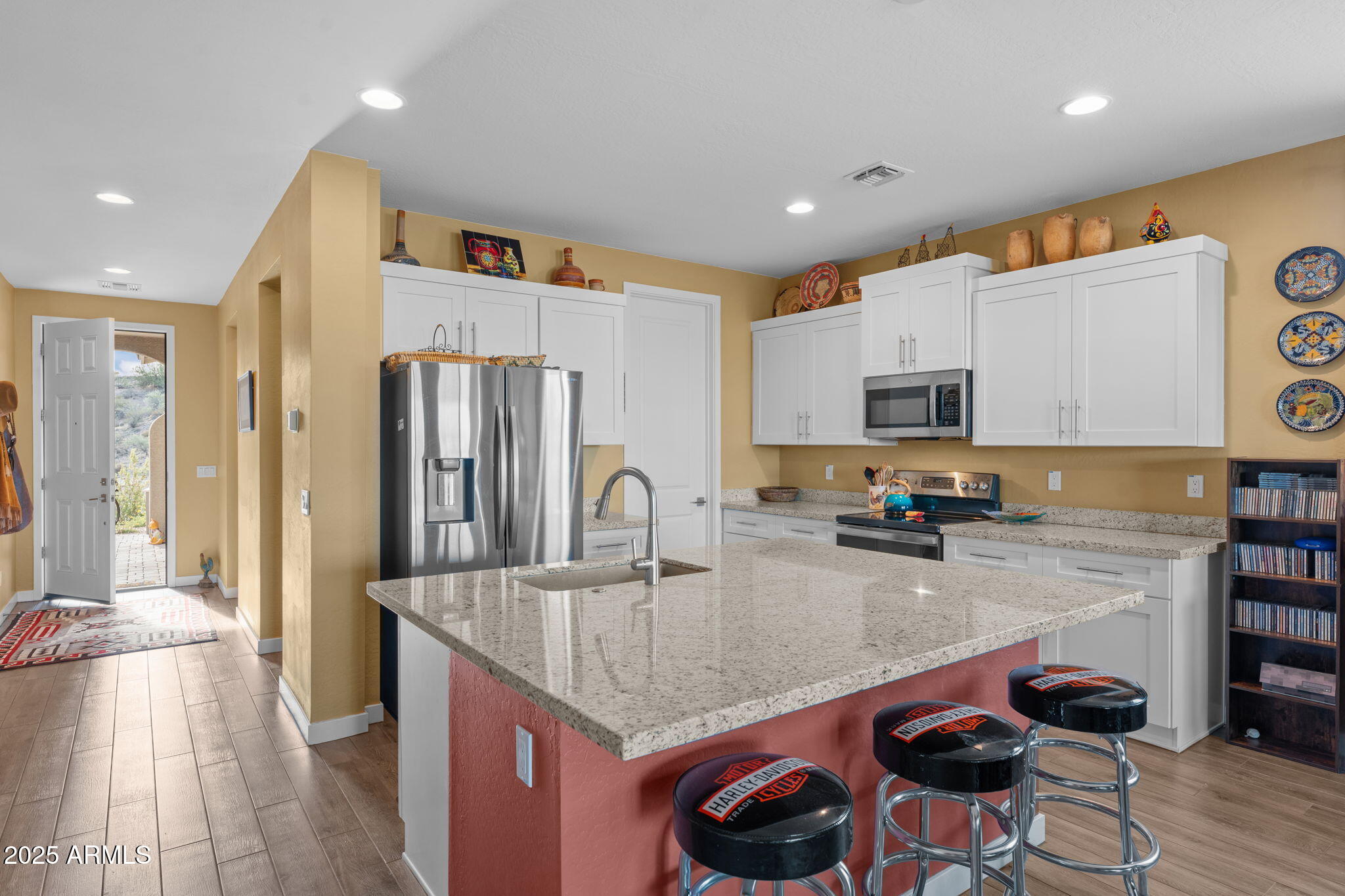 1900 West Ringo Road Wickenburg, AZ 85390 - Photo 9 of 37 a kitchen with stainless steel appliances granite countertop a sink a stove and a refrigerator