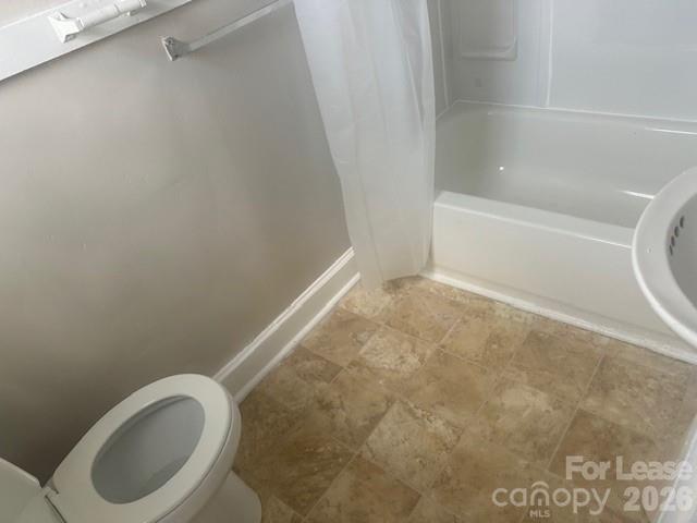 4911 Monroe Road Charlotte, NC 28205 - Photo 13 of 15 a bathroom with a toilet and a bath tub