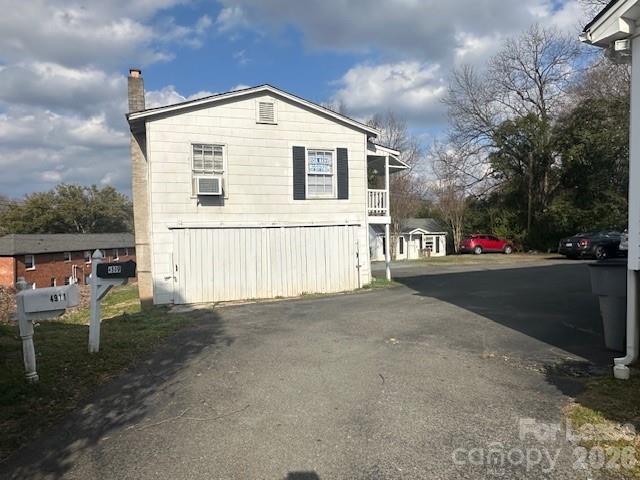 4911 Monroe Road Charlotte, NC 28205 - Photo 2 of 15 a front view of a house with a yard and garage