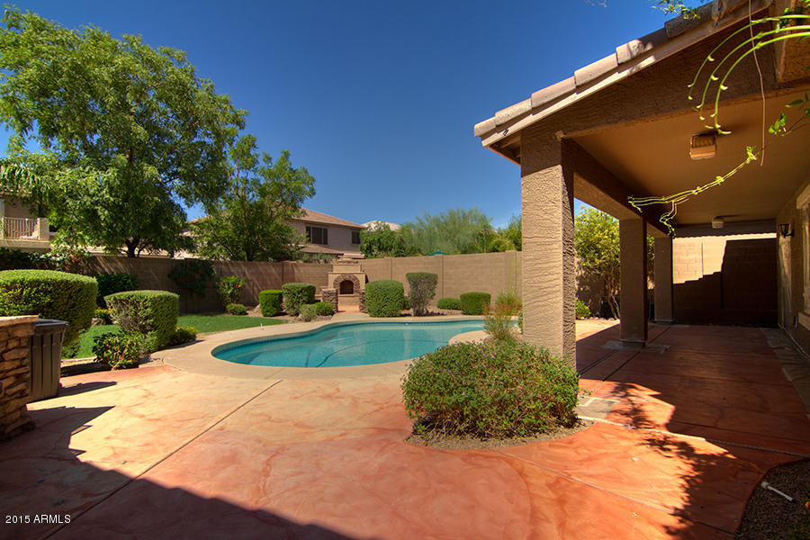 2404 West Roy Rogers Road Phoenix, AZ 85085 - Photo 3 of 35 a view of a backyard with table and chairs potted plants and barbeque