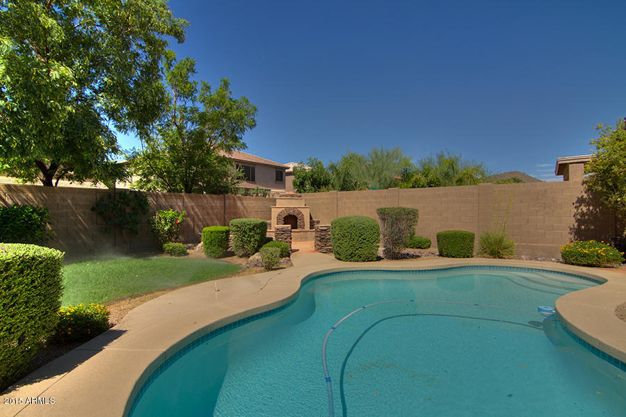 2404 West Roy Rogers Road Phoenix, AZ 85085 - Photo 32 of 35 a view of a house with pool and a yard