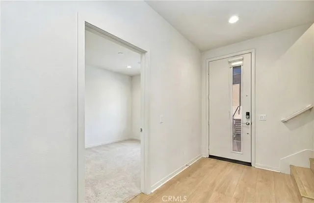 an empty room with a bathroom and mirror