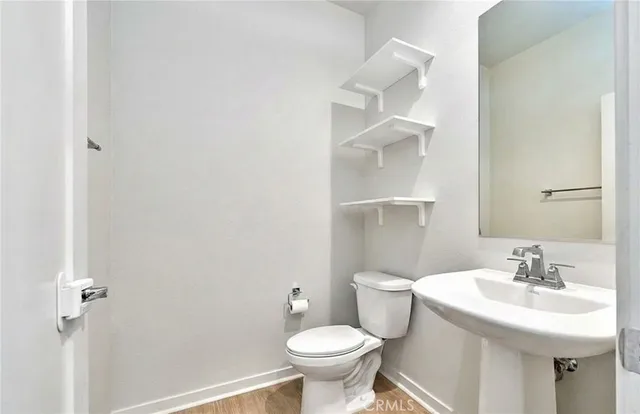 a bathroom with a sink toilet and a mirror