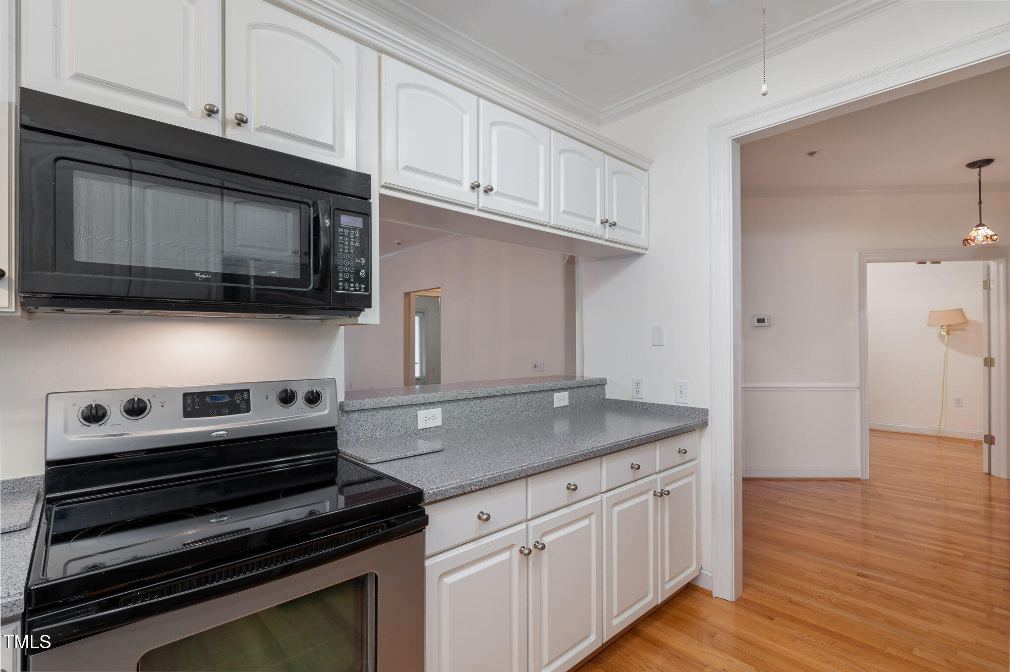 7530 Lead Mine Road, Unit 102 Raleigh, NC 27615 - Photo 8 of 18 a kitchen with cabinets appliances and a wooden floor