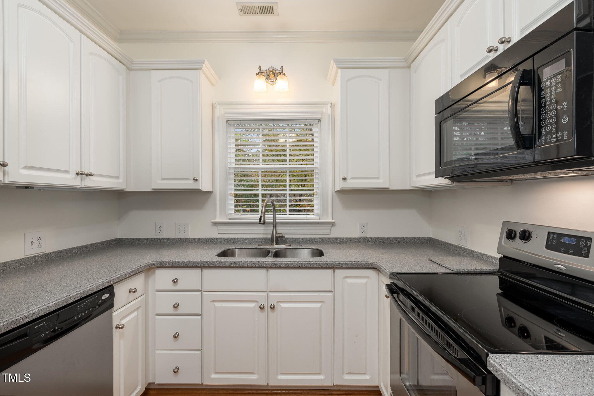 7530 Lead Mine Road, Unit 102 Raleigh, NC 27615 - Photo 10 of 18 a kitchen with cabinets appliances a sink and a window