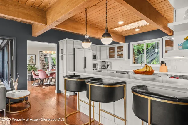 a dining room with furniture and wooden floor