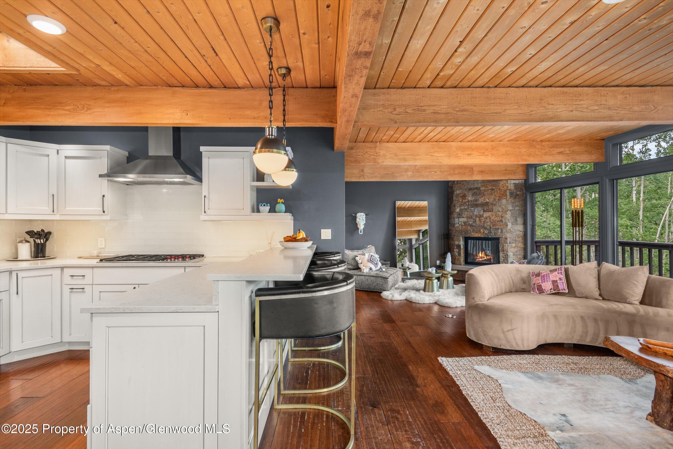 49 Elk Ridge Lane Snowmass Village, CO 81615 - Photo 12 of 38 a living room with fireplace furniture and a wooden floor