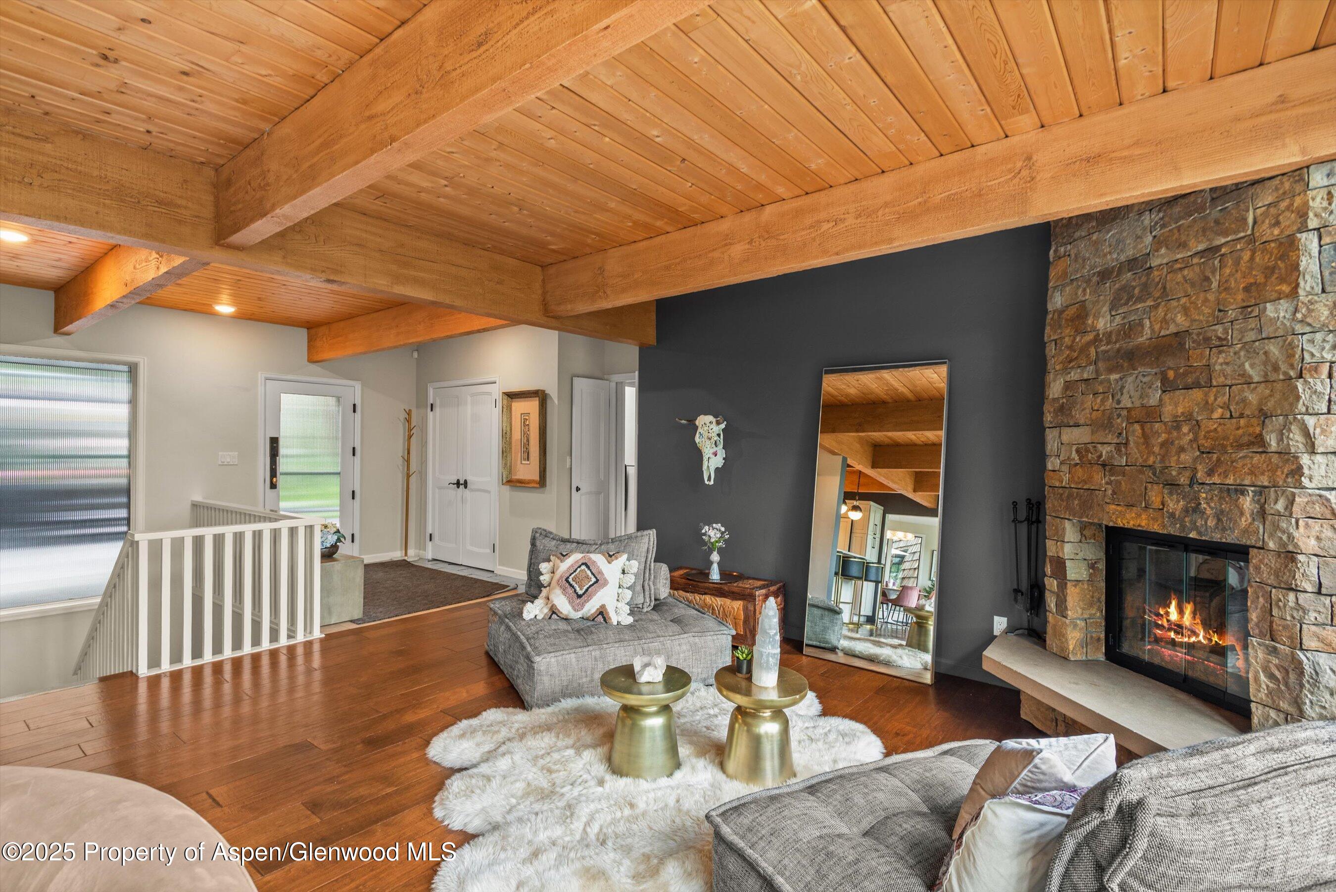 49 Elk Ridge Lane Snowmass Village, CO 81615 - Photo 18 of 38 a living room with furniture and a fireplace