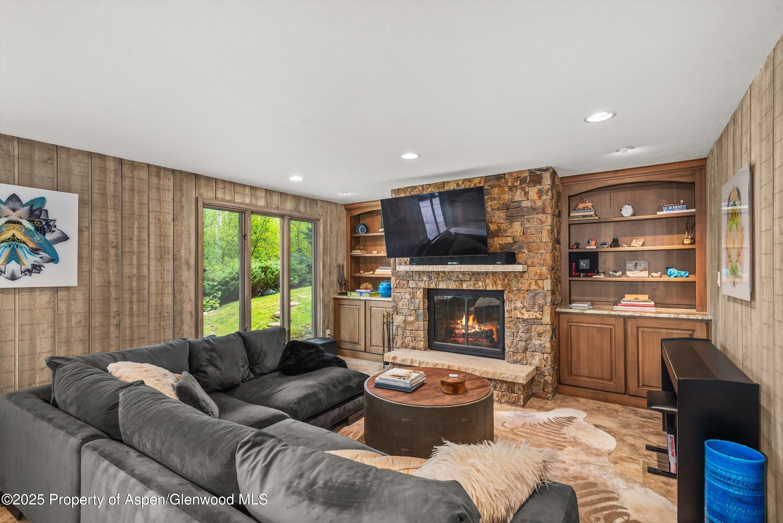 49 Elk Ridge Lane Snowmass Village, CO 81615 - Photo 22 of 38 a living room with furniture and a fireplace
