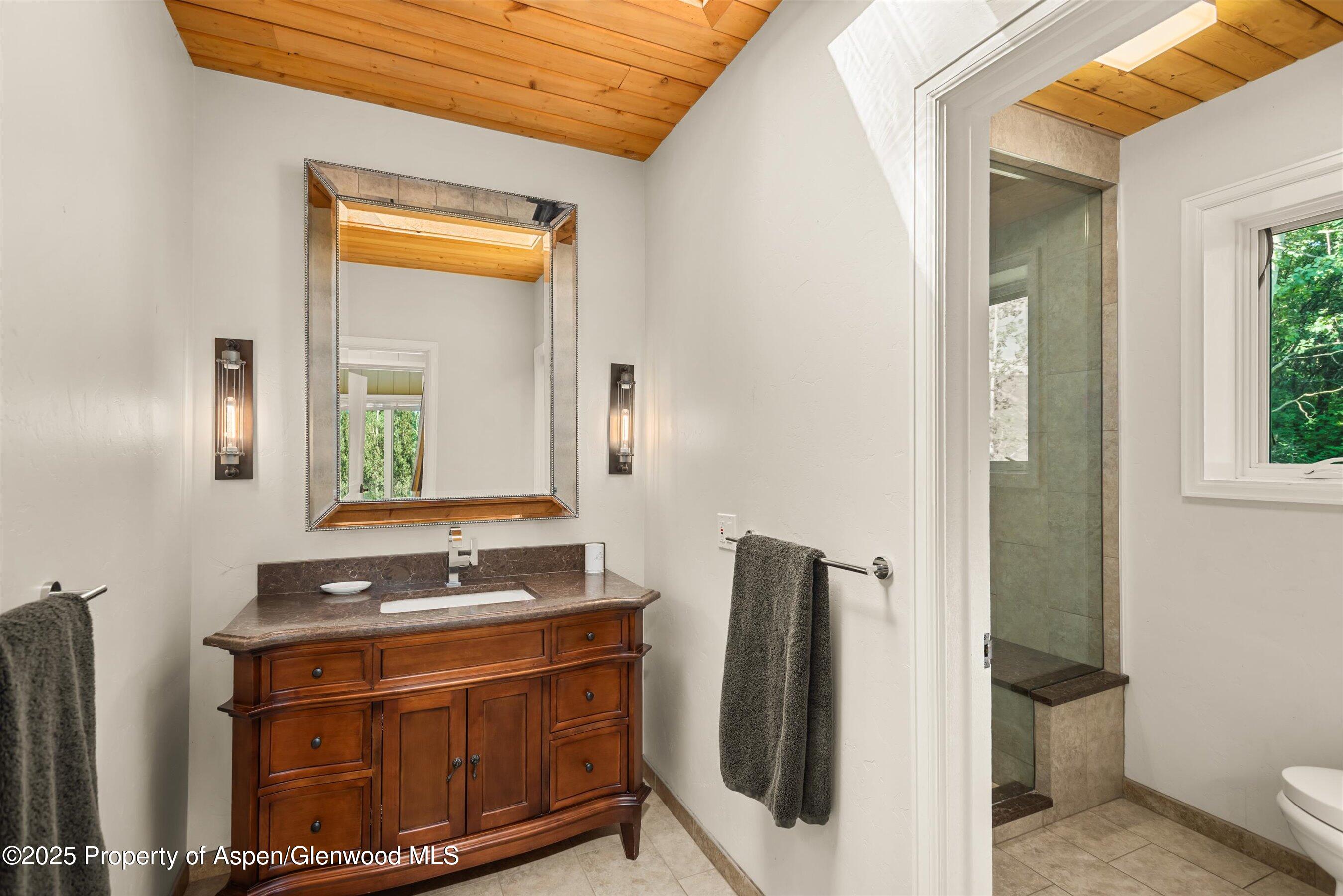 49 Elk Ridge Lane Snowmass Village, CO 81615 - Photo 26 of 38 a bathroom with a sink and a mirror