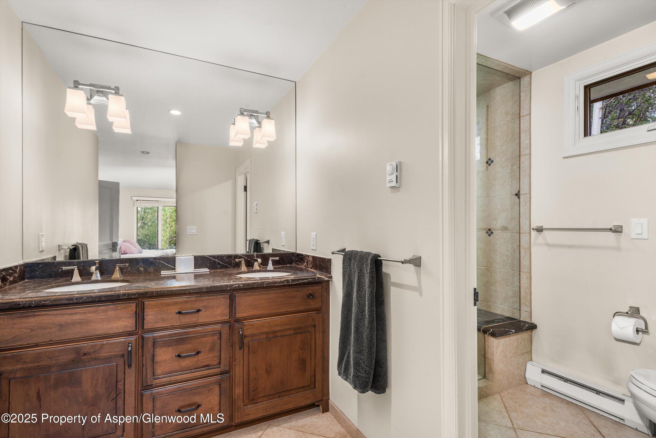 49 Elk Ridge Lane Snowmass Village, CO 81615 - Photo 31 of 38 a bathroom with a double vanity sink and mirror with shower