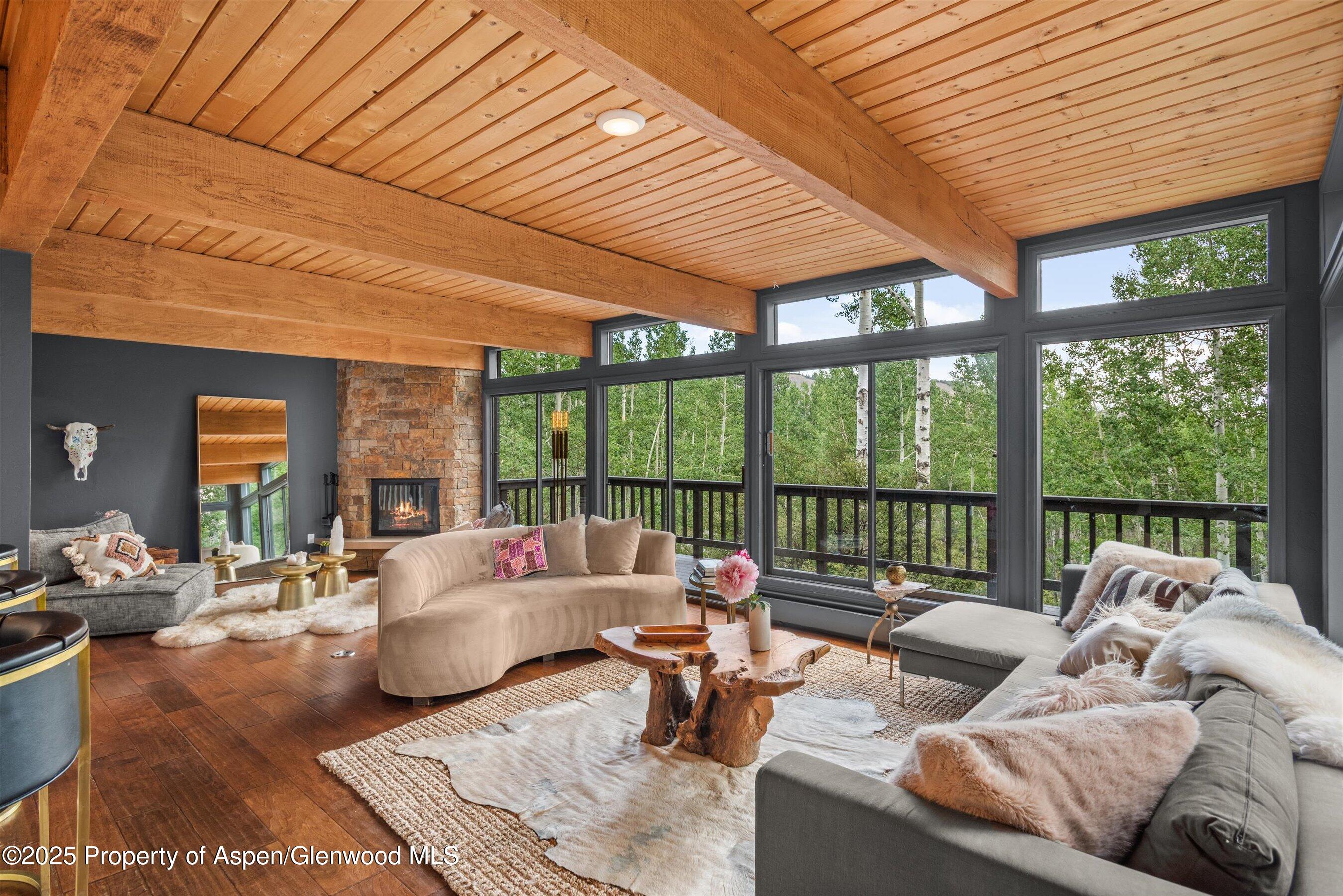 49 Elk Ridge Lane Snowmass Village, CO 81615 - Photo 6 of 38 a living room with furniture and floor to ceiling windows