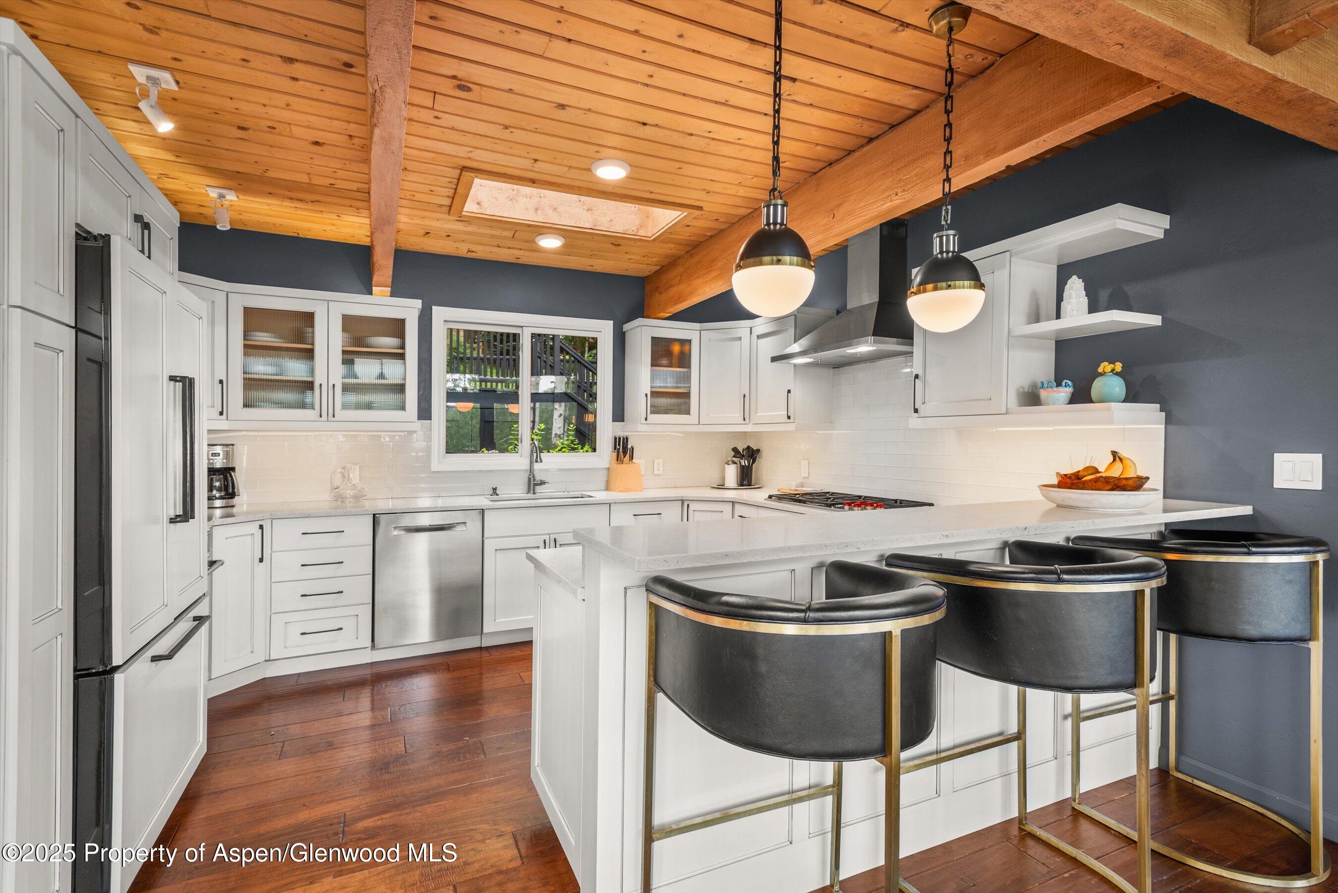 49 Elk Ridge Lane Snowmass Village, CO 81615 - Photo 8 of 38 a kitchen with stainless steel appliances granite countertop a sink and cabinets