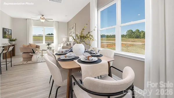 a dining room with furniture window and wooden floor