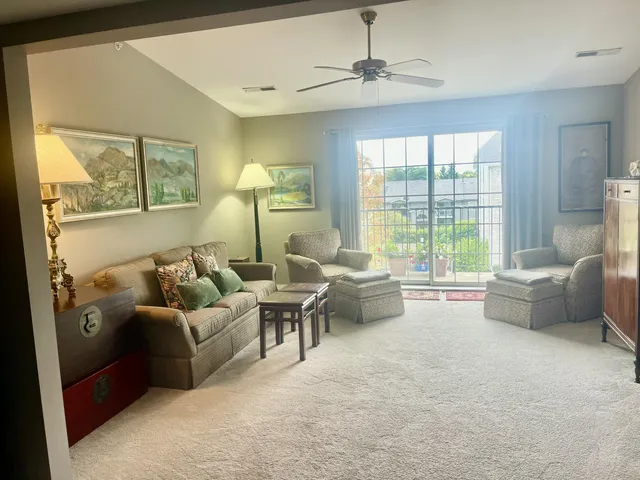a living room with furniture and a mirror