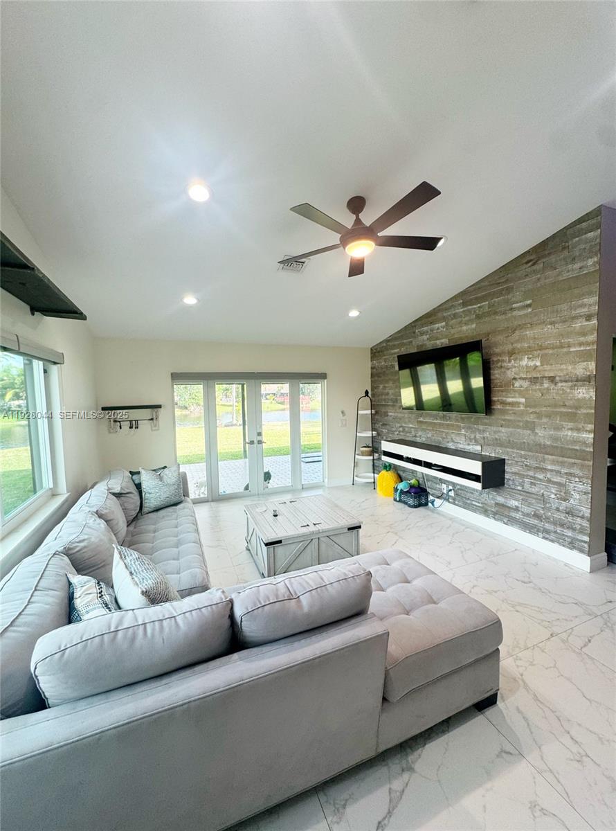 15500 Carriage Court Davie, FL 33331 - Photo 12 of 26 a living room with furniture and a flat screen tv