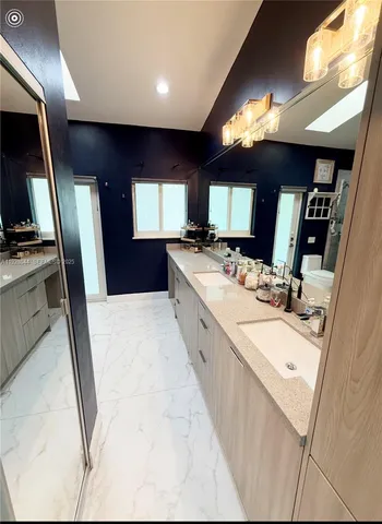 a bedroom with a bed and a large mirror