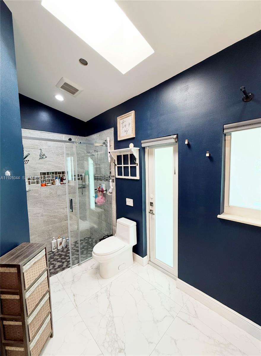 15500 Carriage Court Davie, FL 33331 - Photo 17 of 26 a bedroom with a bed and a large mirror