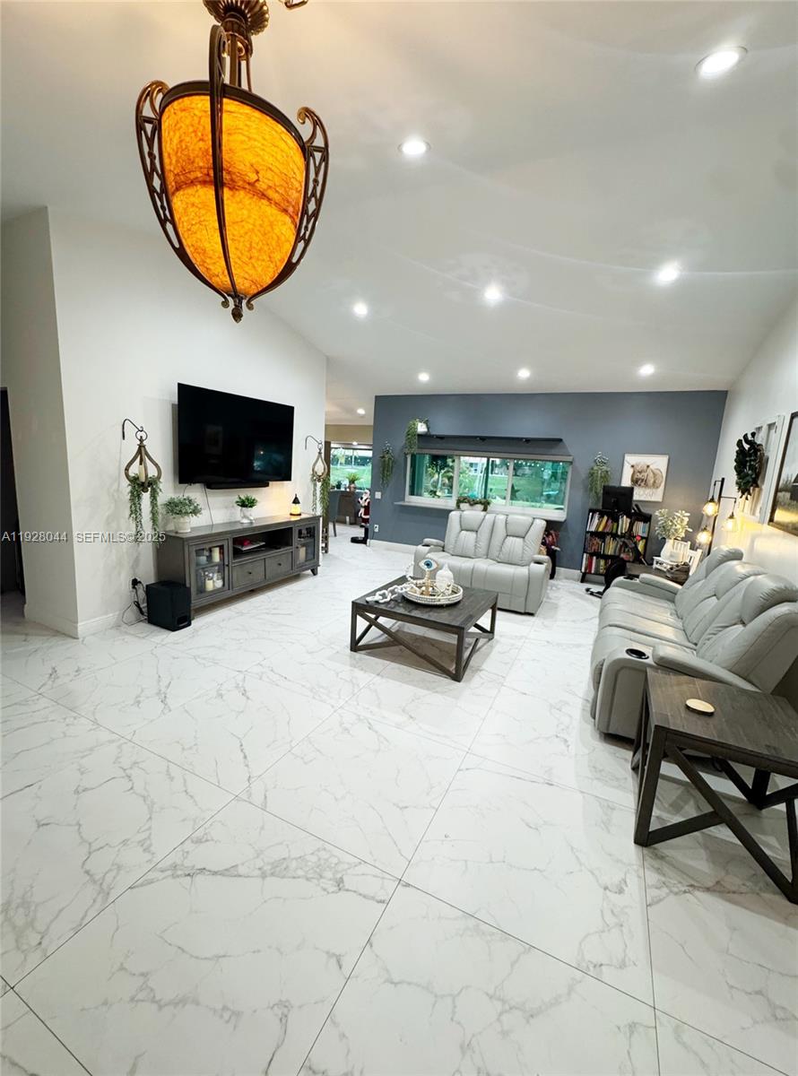 15500 Carriage Court Davie, FL 33331 - Photo 2 of 26 a living room with furniture and a flat screen tv