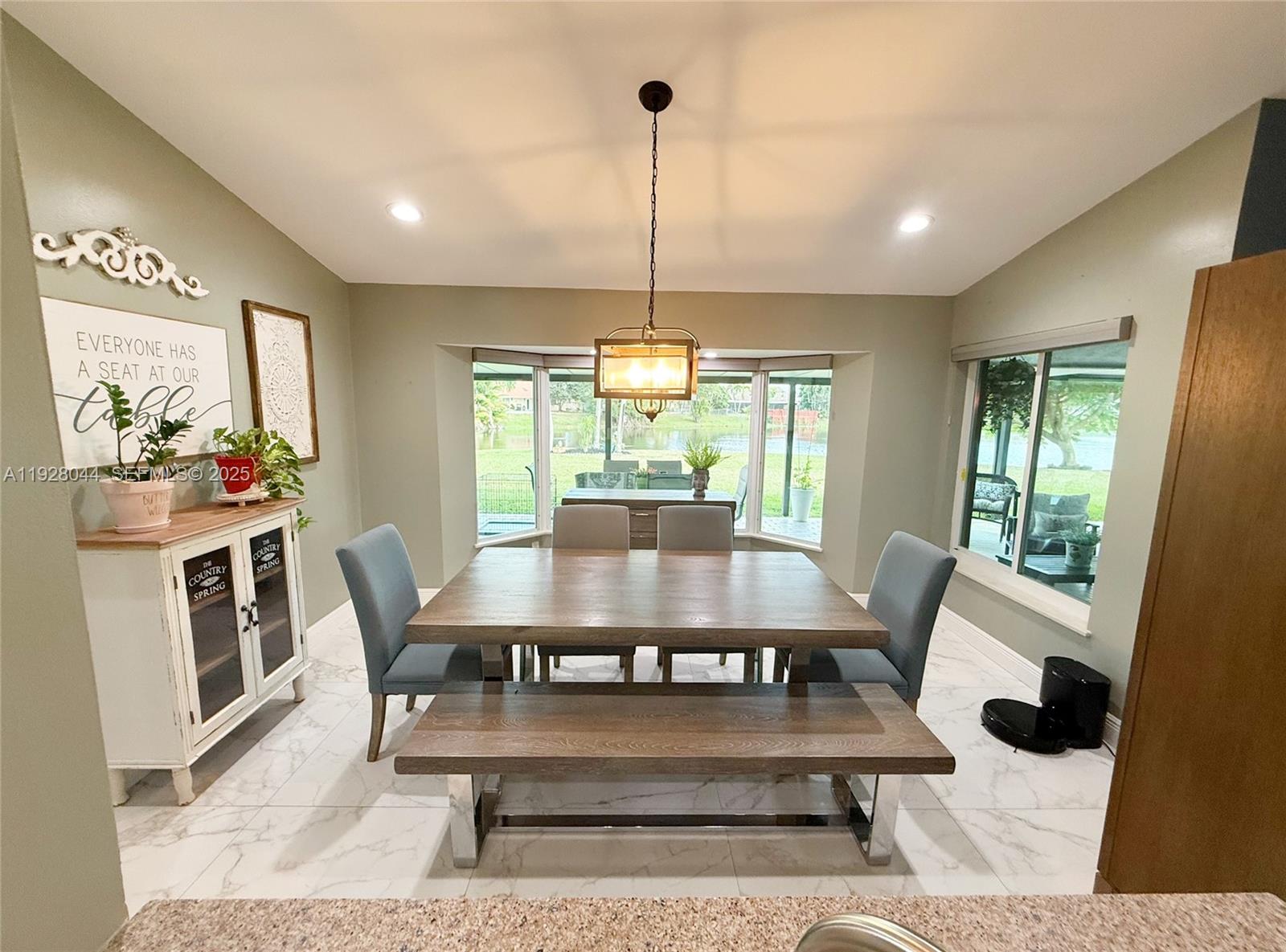 15500 Carriage Court Davie, FL 33331 - Photo 5 of 26 a view of a dining room with furniture wooden floor and chandelier