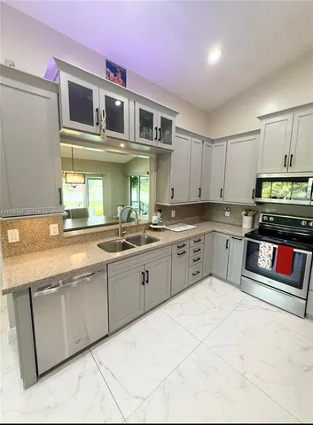 a bathroom with a granite countertop double vanity sink and mirror