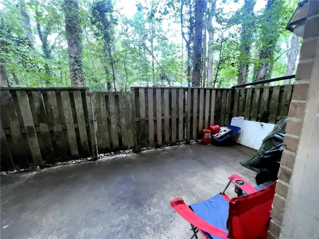 a view of a backyard with a small cabin and a chair